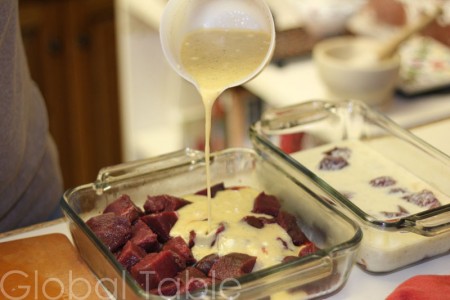 Mango marinade is poured over kangaroo. Pineapple marinade on the right.