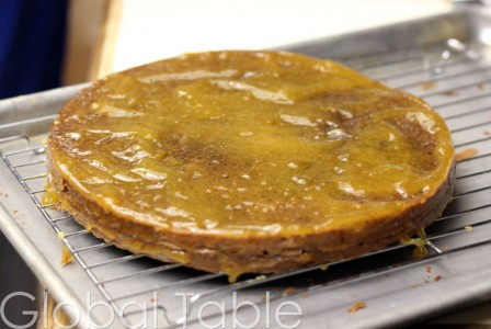 Apricot jam covering the cake, and between the layers