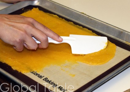 Fruit is spread on silpat before going into the oven to dry