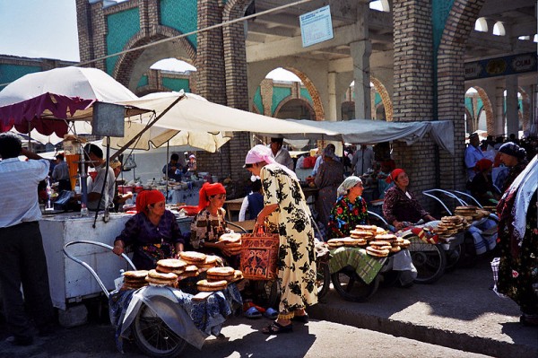 Bread sellers with their traditional flat round loaves of Uzbek bread. Photo by upyernoz.