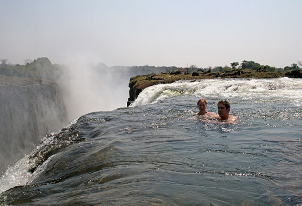 Swimming at the edge of the falls in a naturally formed safe pool, accessed via Livingstone Island. Photo by Ian Restall.