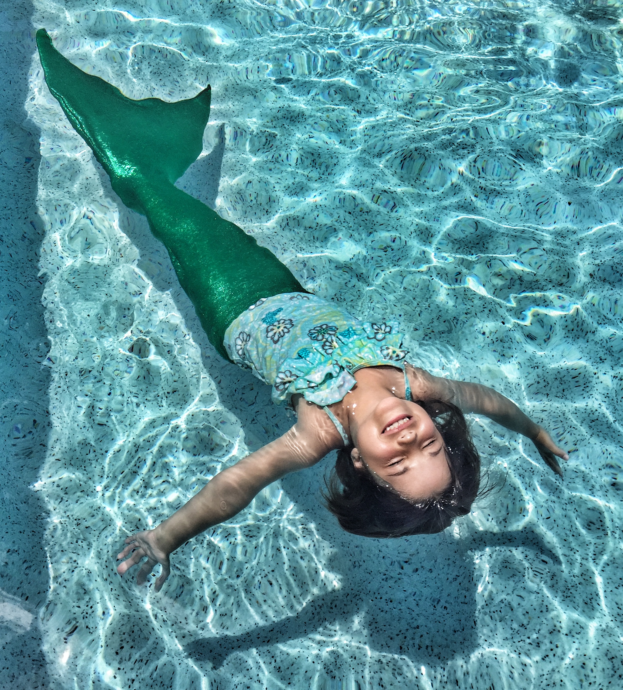 Mermaid Swimming Under Water by Ariel Skelley